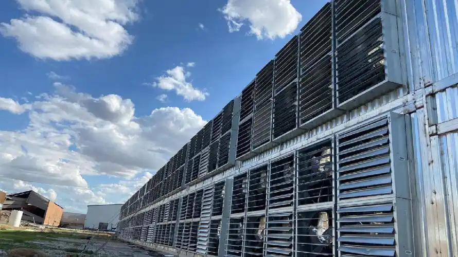 Miners on a rack inside a mining farm